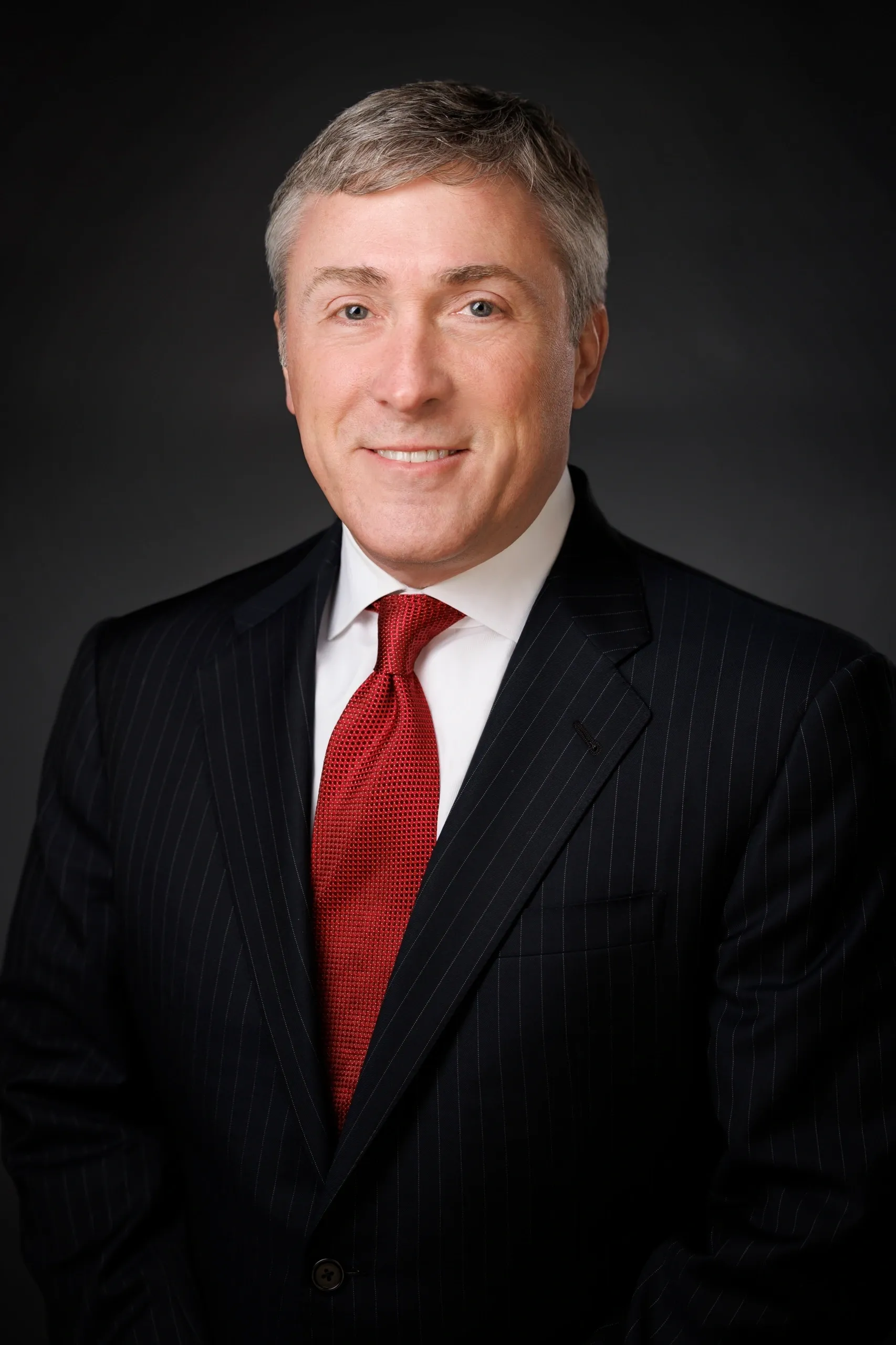 Man in a suit with a red tie.